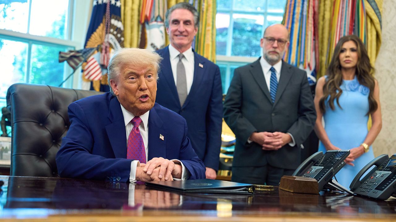 President Donald Trump speaks with reporters in the Oval Office of the the White House, Tuesday, June 10, 2025, in Washington, as from left, Interior Secretary Doug Burgum, Office of Management and Budget Director Russell Vought, and Homeland Security Secretary Kristi Noem, listen. (AP Photo/Evan Vucci)