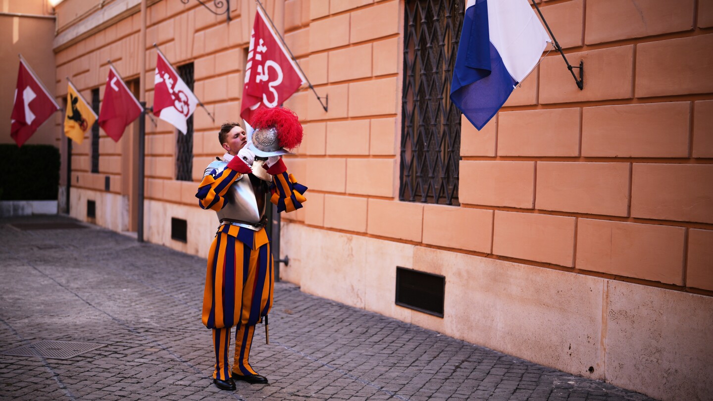 A look at Swiss Guards preparing for a swearing-in ceremony attended by the Pope, in photos