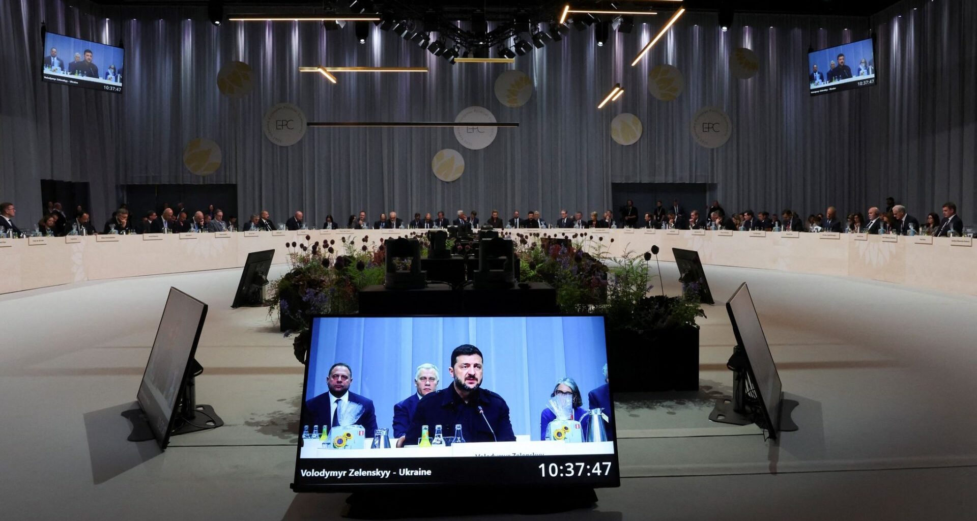 A screen displays Ukrainian President Volodymyr Zelensky speaking during the 7th European Political Community (EPC) Summit at the Bella Center in Copenhagen