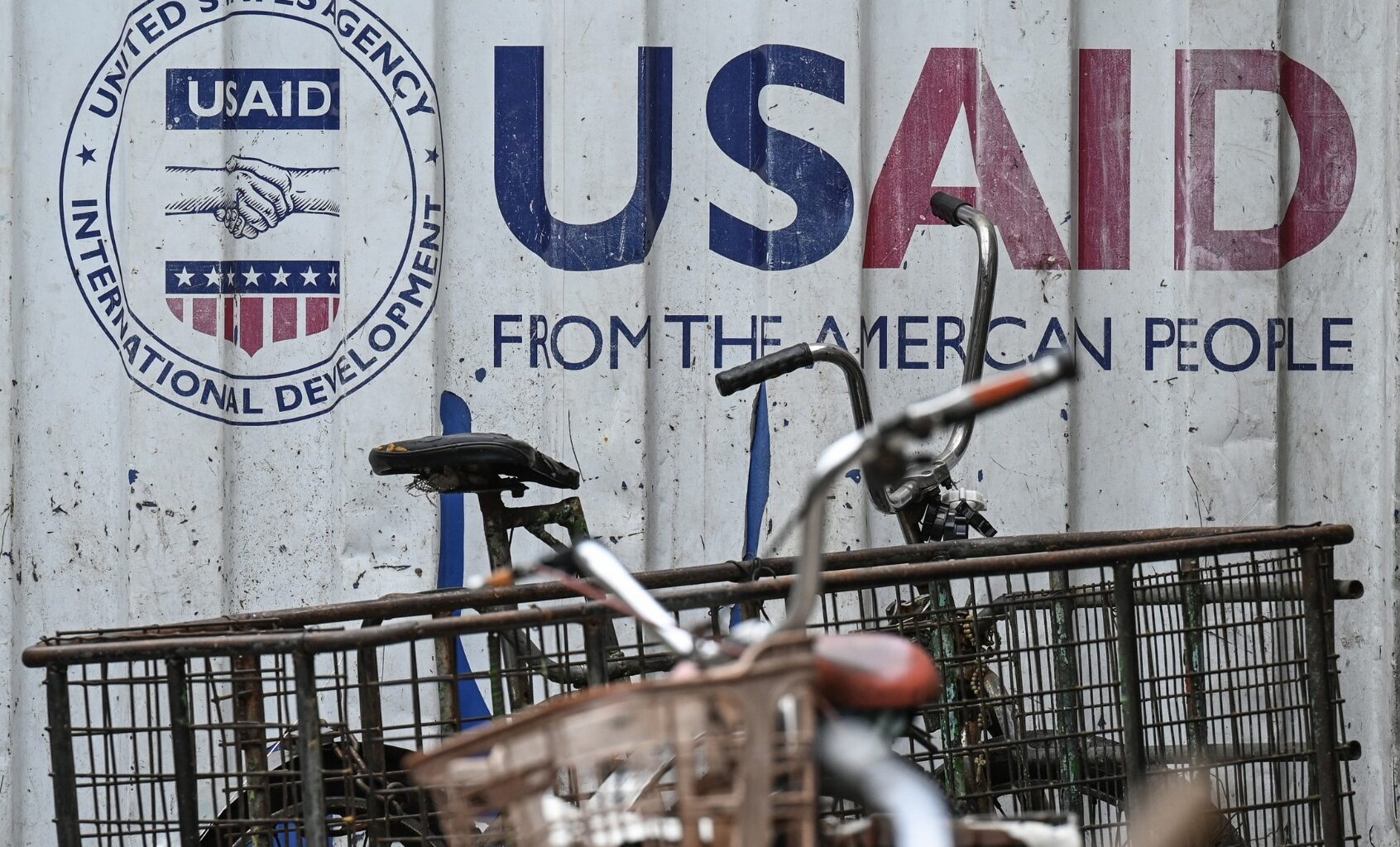 Signage for the US government's humanitarian agency USAID is seen on a cargo container beside a tricycle in Manila on February 4, 2025. (JAM STA ROSA/AFP via Getty Images)