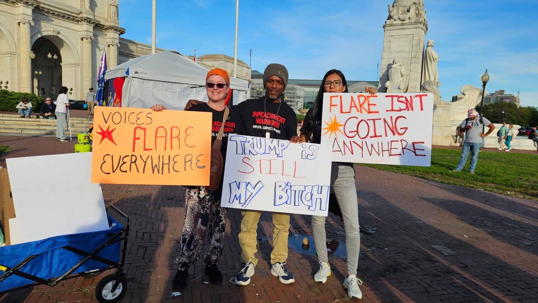protesters standing with signs