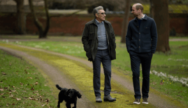 Prince William walking with Eugene Levy and Orla the dog through a park