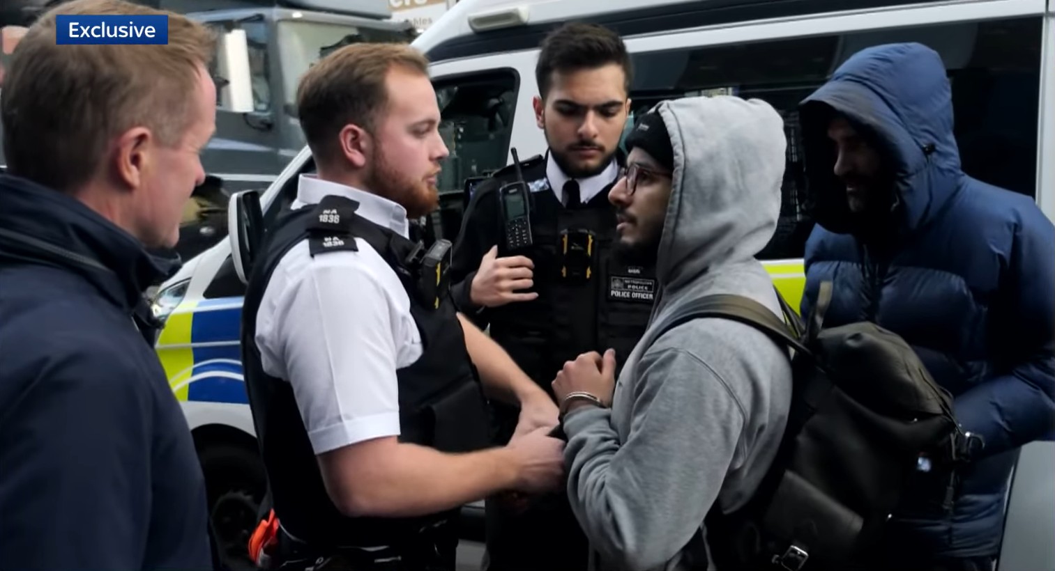 Police officers arresting Brahim Kaddour-Cherif.