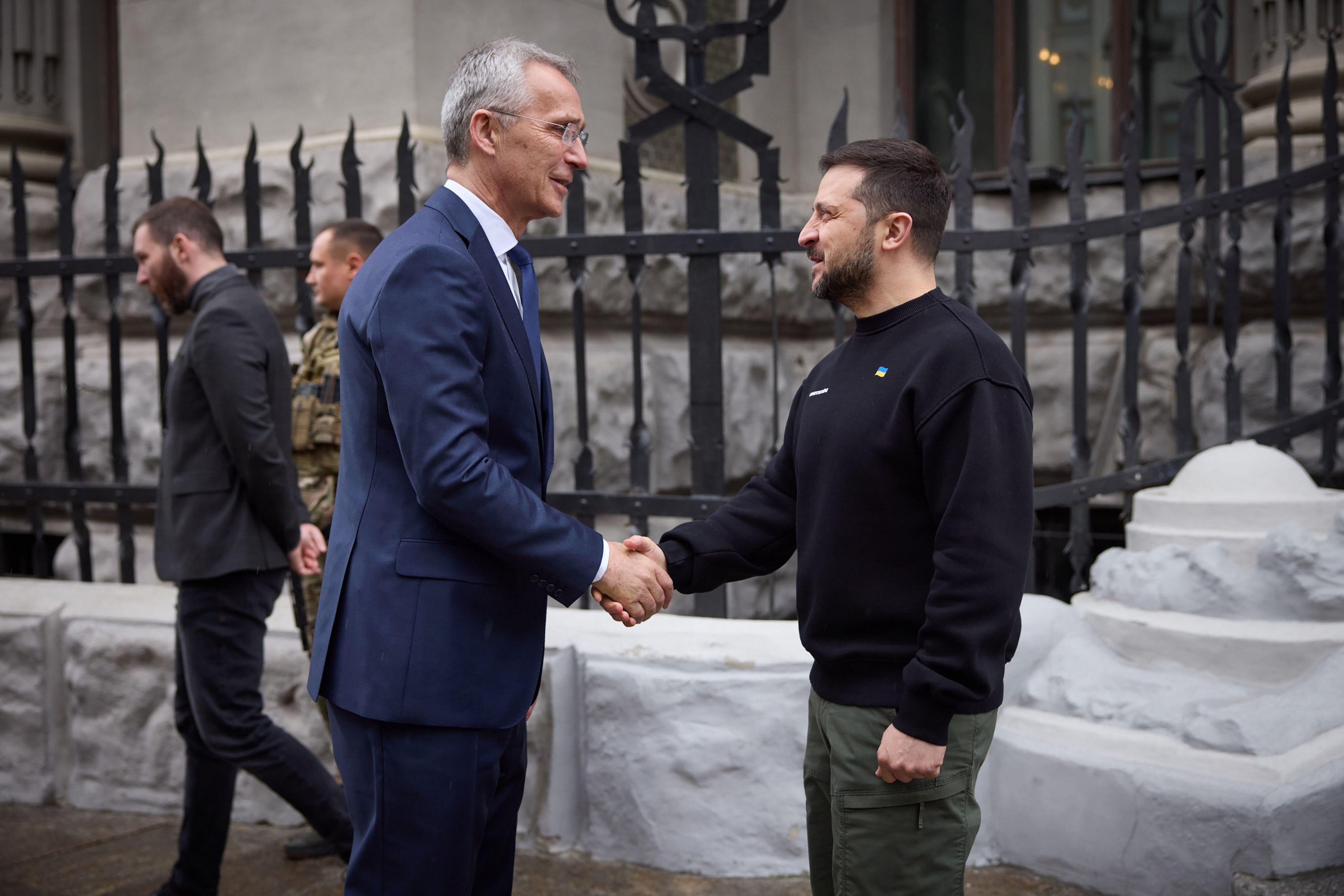 Ukrainian President Volodymyr Zelenskyy and NATO Secretary General Jens Stoltenberg shaking hands.