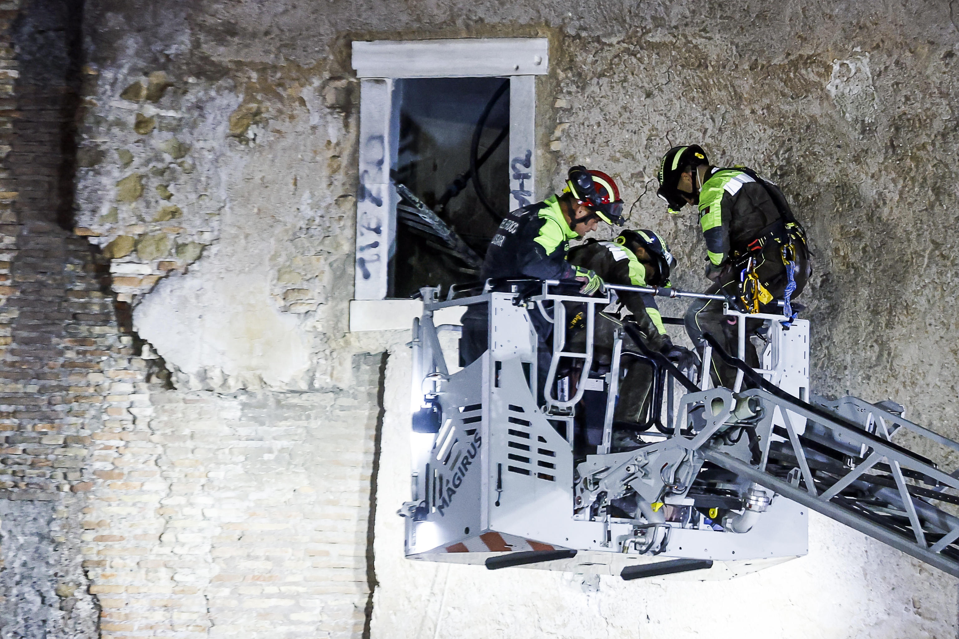 Firefighters rescuing a worker from a collapsed section of the Torre dei Conti in Rome.