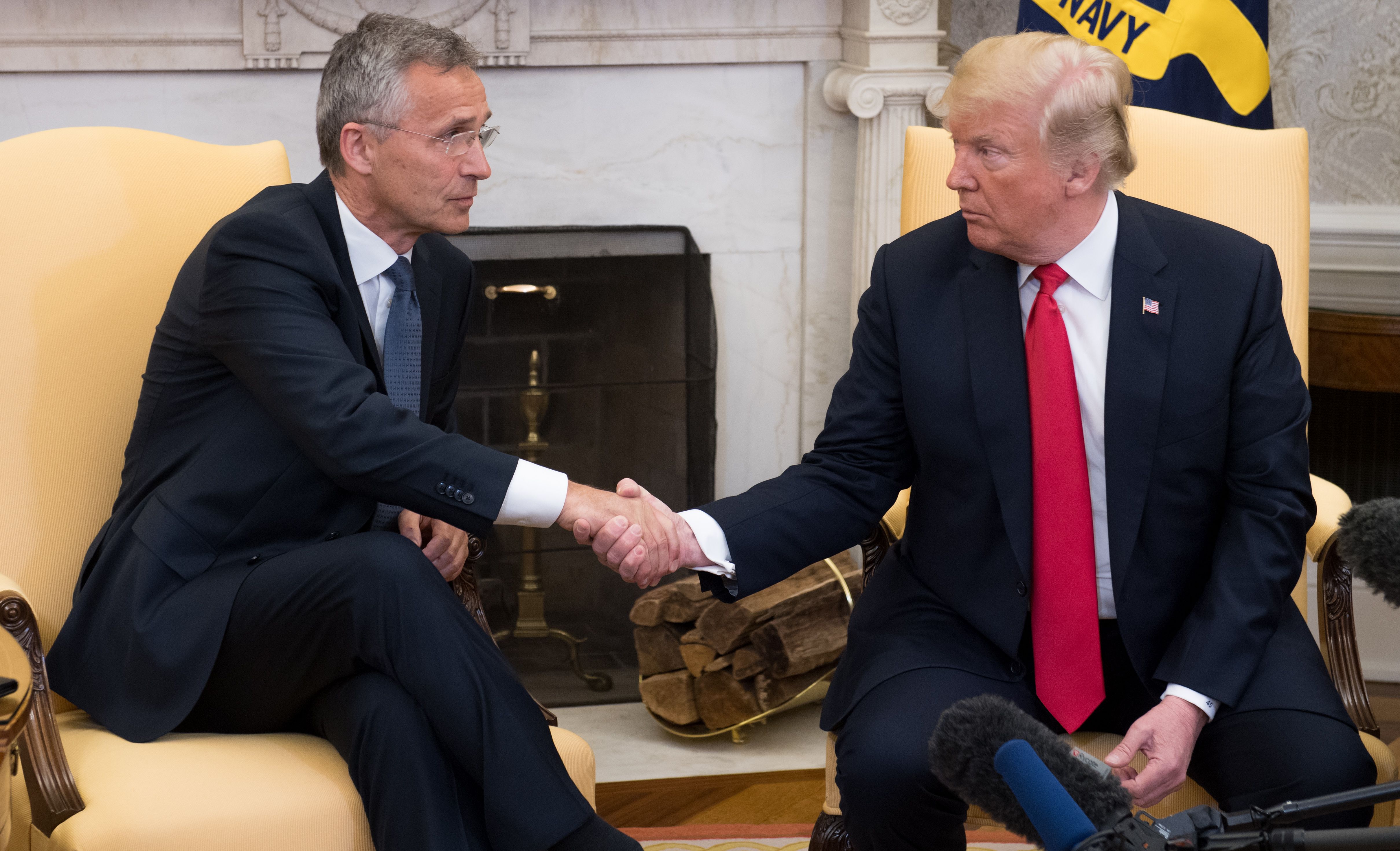 US President Donald Trump shakes hands with NATO Secretary General Jens Stoltenberg in the Oval Office.
