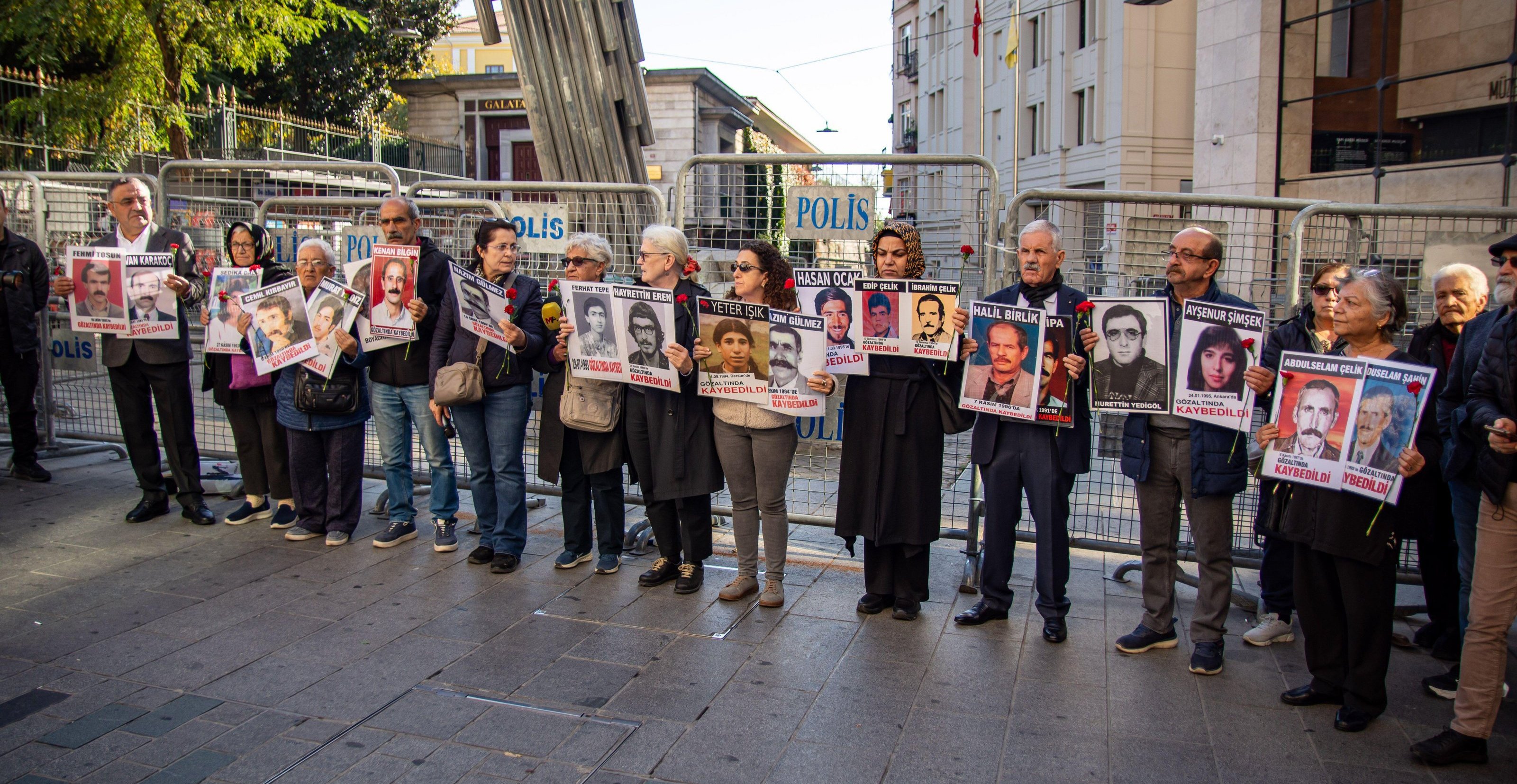 The Saturday Mothers protest in Galatasaray Square, Istanbul, holding signs with photos of disappeared individuals.