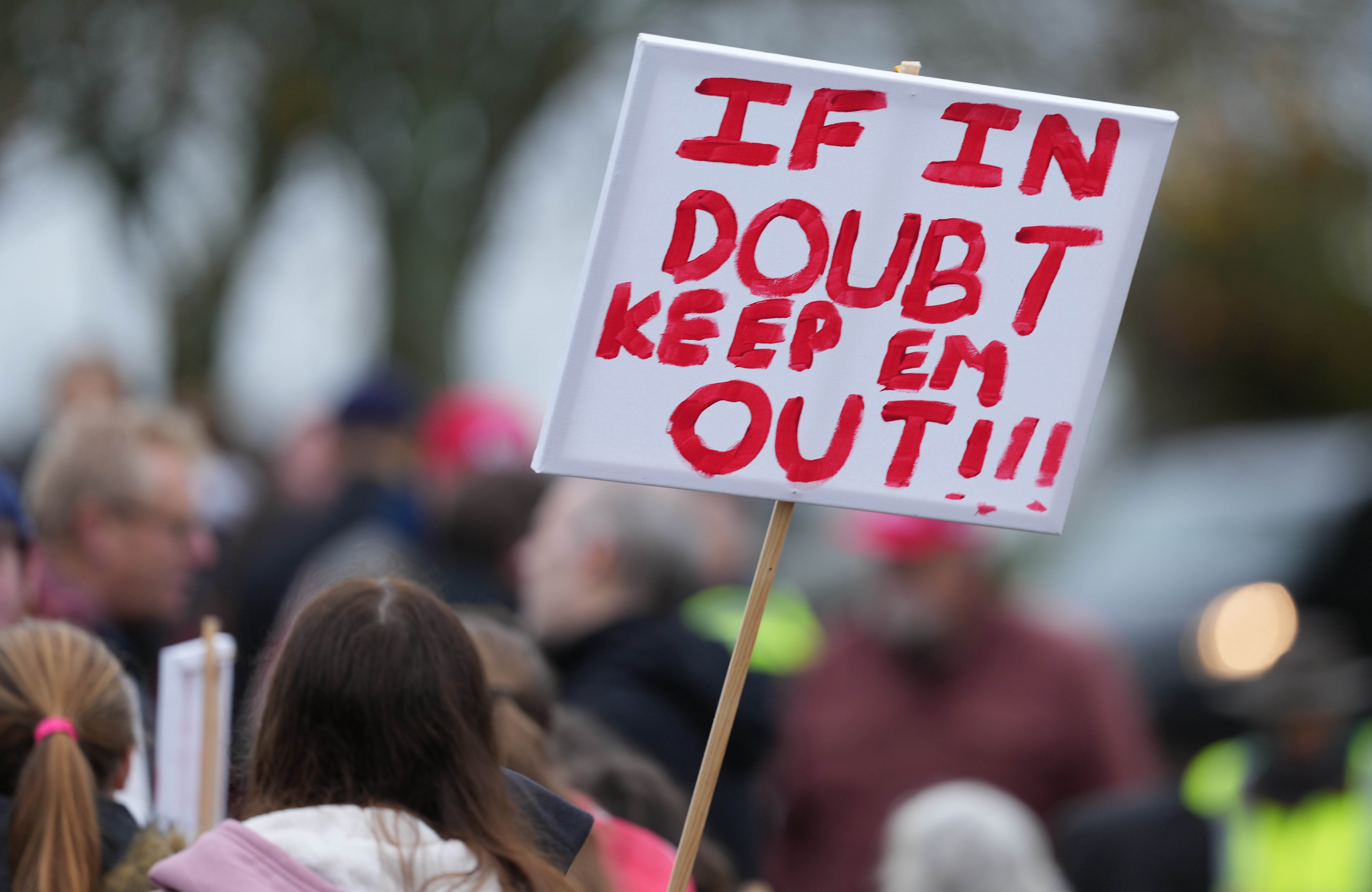 Protest sign that reads "IF IN DOUBT KEEP EM OUT!!!"
