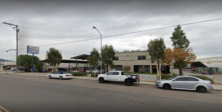The outside of an industrial building as seen on a gloomy, gray day.