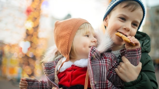brother and sister sharing a christmas cookie
