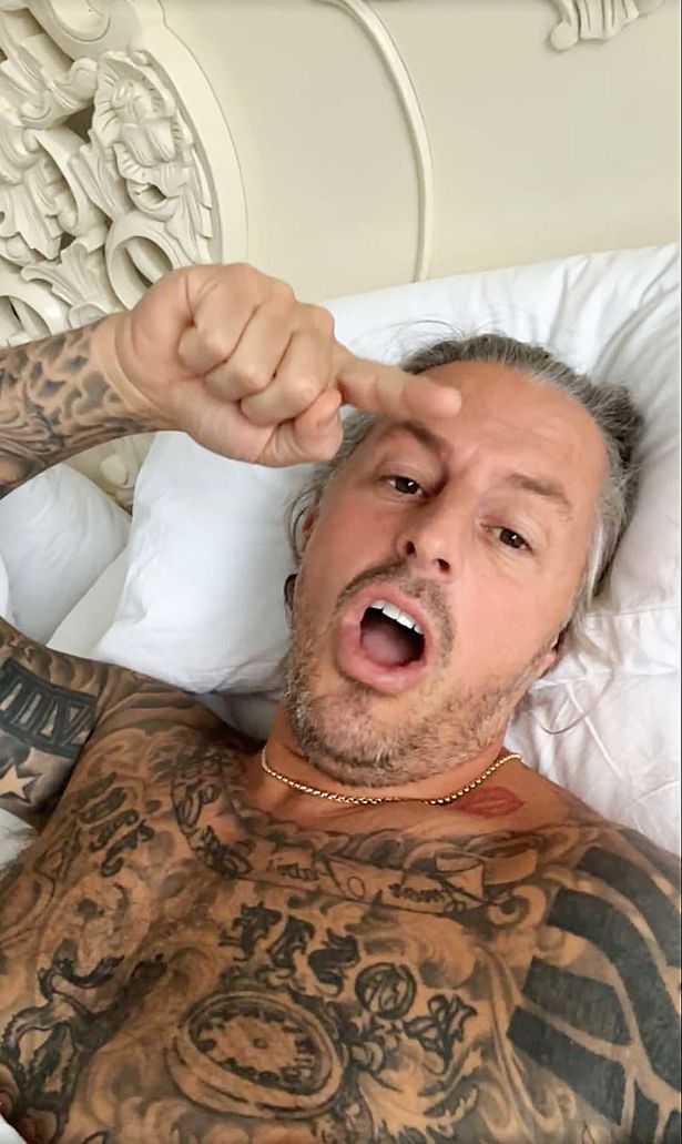 Appearing topless in bed, tattooed Ryan Bridge.