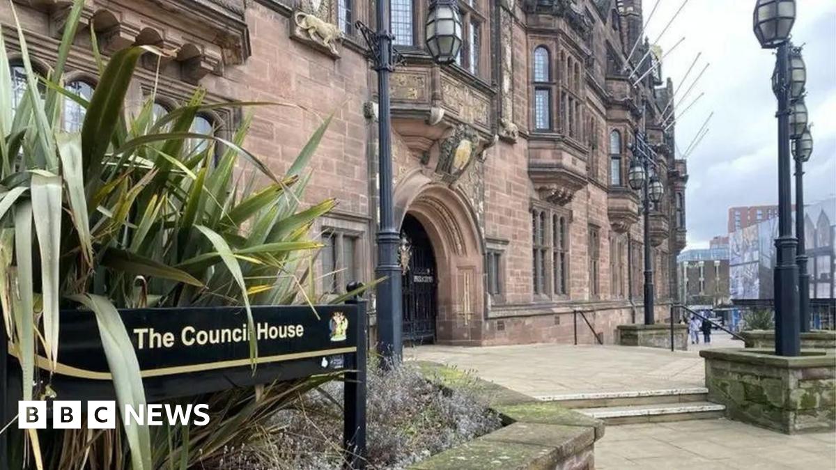 The council offices in Coventry are in a Tudor Revival-style building, built between 1913 and 1917, with an ornate exterior. A sign points to The Council House. People are walking around the building.