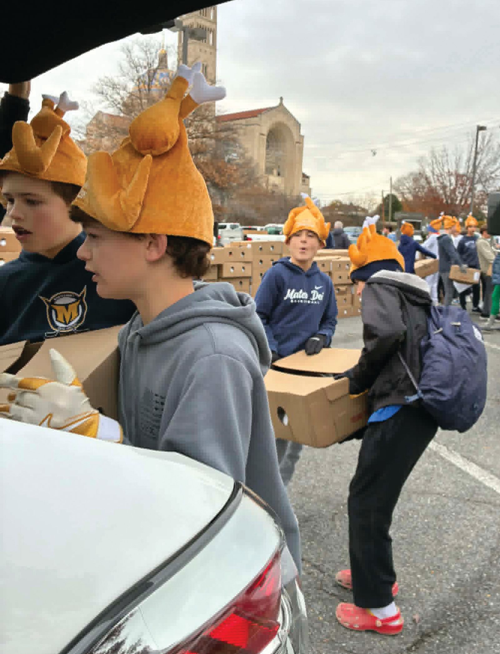 Students from Mater Dei School in Bethesda volunteer at the Poor Robert’s Mission’s annual turkey distribution on Nov. 25 at the National Shrine’s parking lot, loading turkeys for community organizations to distribute to the people they serve. (CS photo by Richard Szczepanowski)