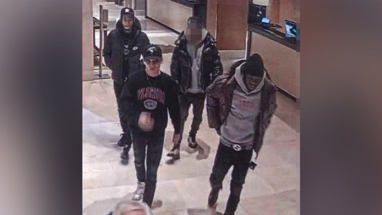 Four men in the lobby of a hotel.