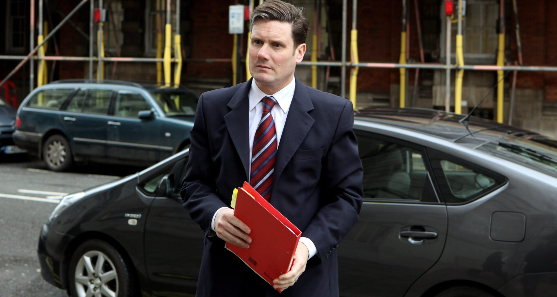 GettyImages 97051158 featuring a dynamic business meeting with professionals engaged in a lively discussion around a confe...