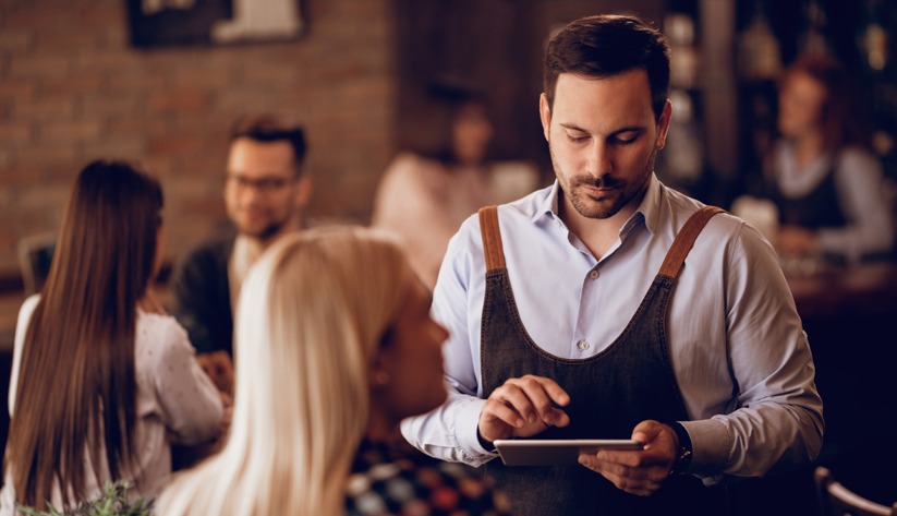 Male server taking order from female customer