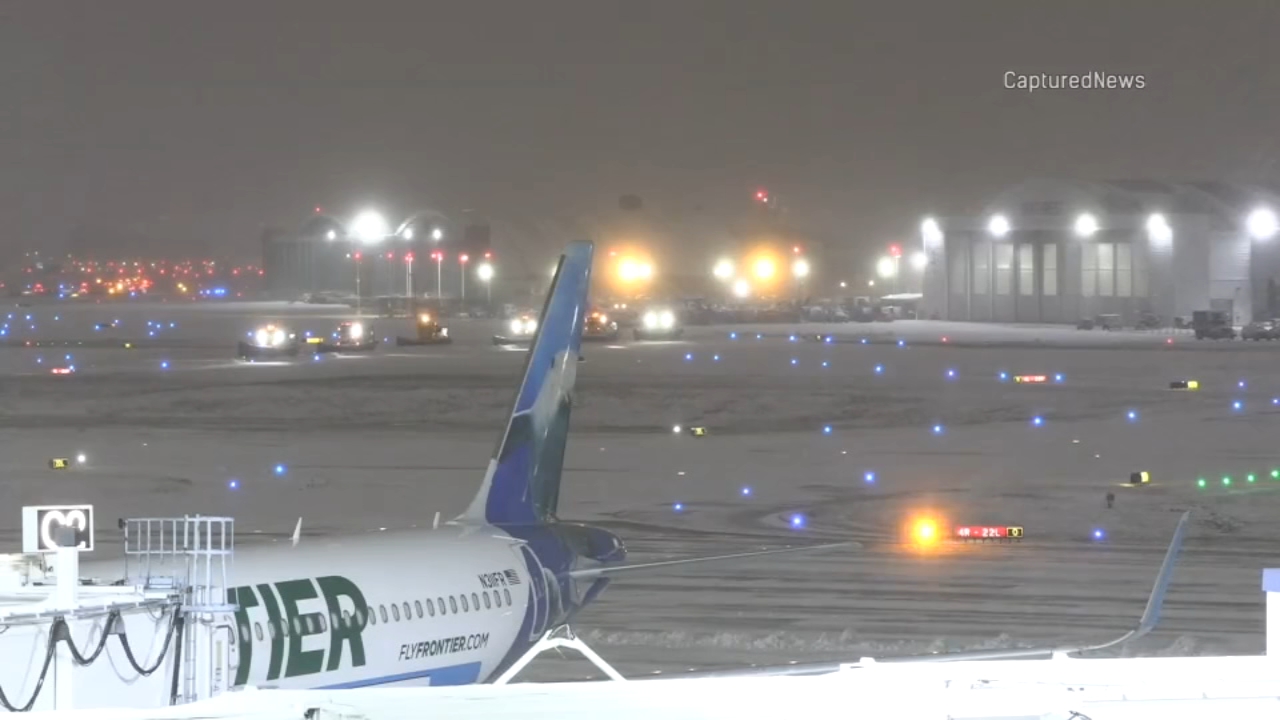 Flight cancellations and delays piled up at Chicago's Midway airport as snow covered runways on Monday.