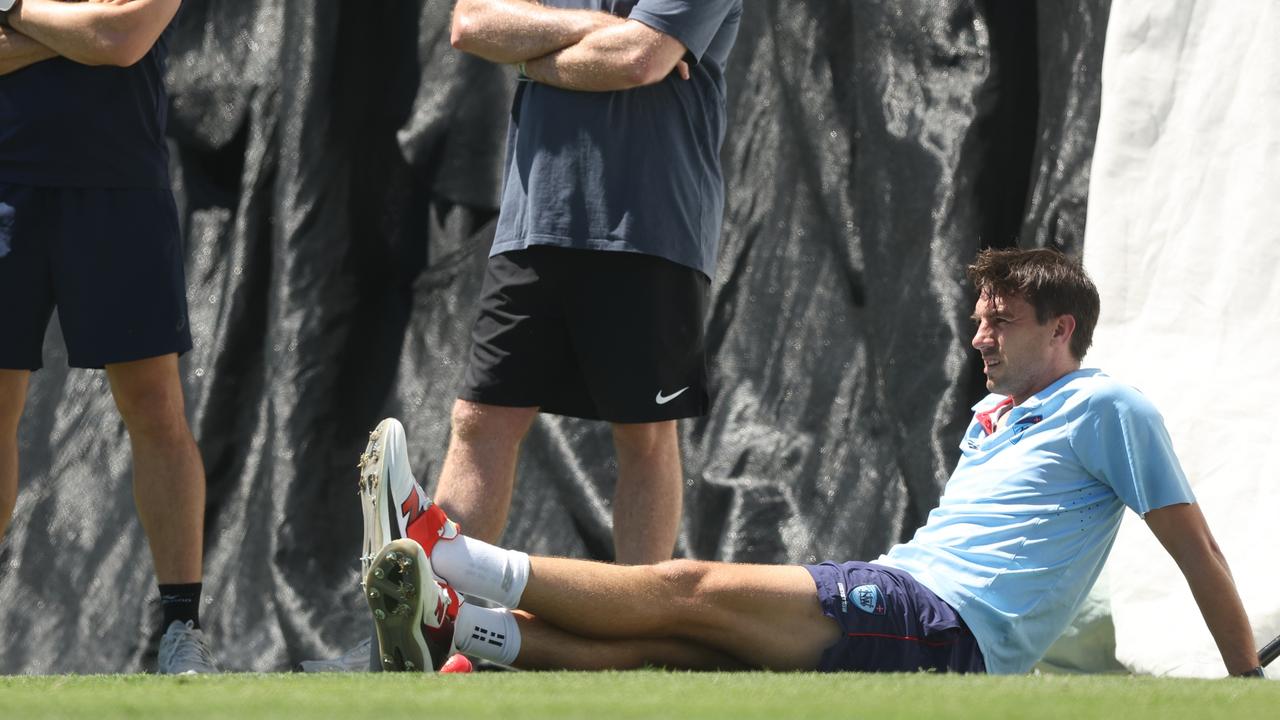 Pat Cummins rests during a practice session at Cricket Central in NSW.
