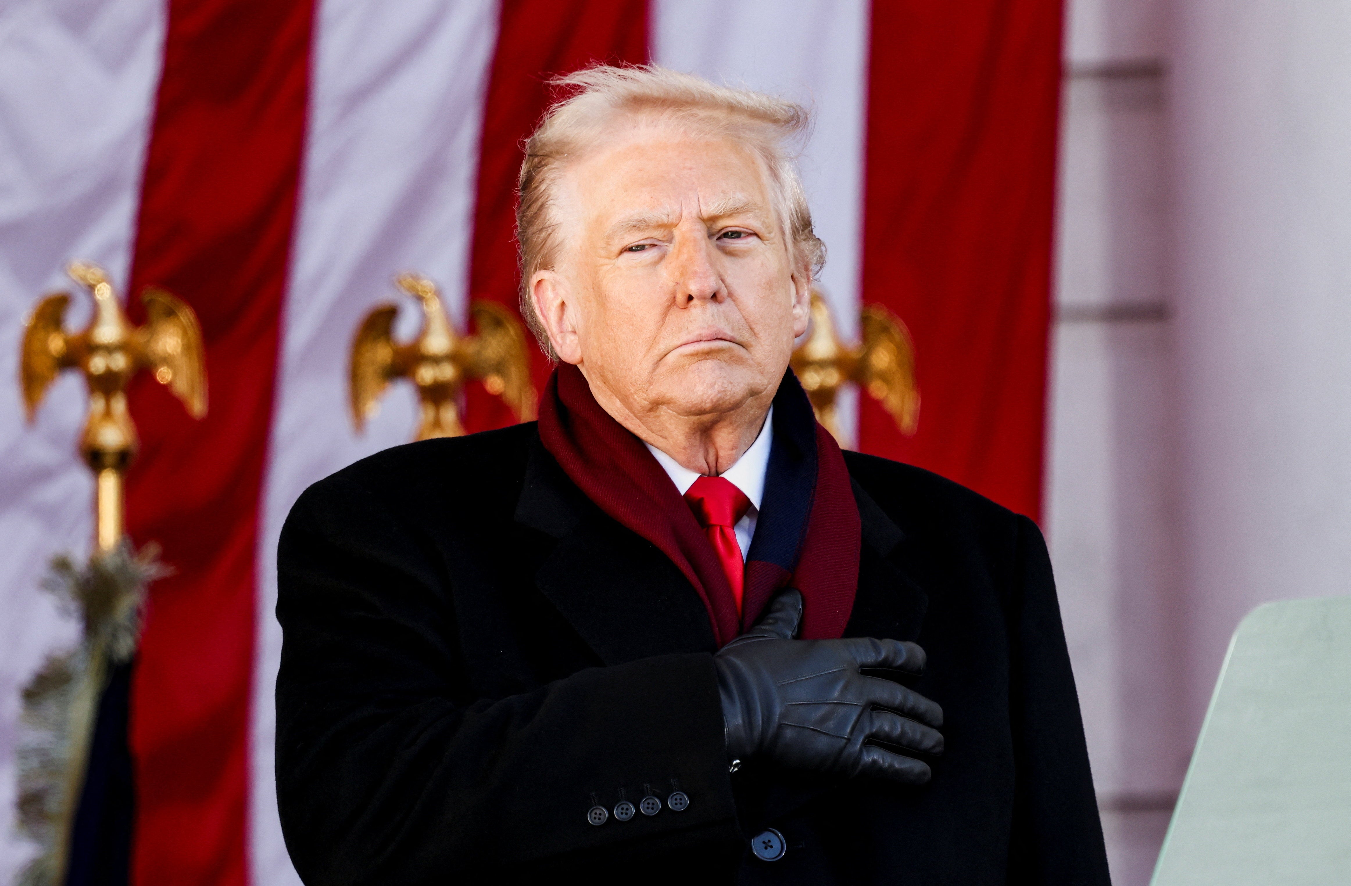 U.S. President Donald Trump places a hand over his heart during a Veterans Day ceremony at Arlington National Cemetery in Arlington, Virginia, U.S., November 11, 2025. REUTERS/Kevin Lamarque