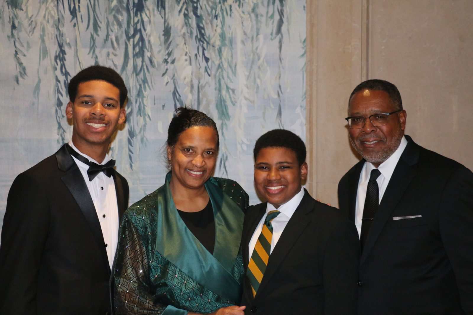 Roy Castleberry Jr., (at left) a senior at Archbishop Carroll High School in Washington and a a graduate of St. Augustine School, spoke about the value of his Catholic education during the 11th annual gala of the Catholic Business Network of Washington, D.C., on Nov. 6. Afterward, he posed for a photo with his parents and his brother. (Photo courtesy of CBN-DC)