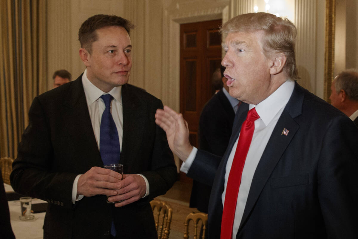 President Donald Trump, right, talks with Tesla and SpaceX CEO Elon Musk at the White House in ...