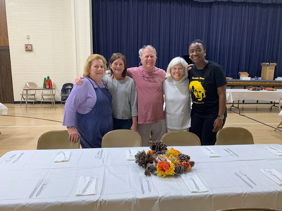 Tallahassee Fellowship members join an IRC employee in setting up for the 2024 Thanksgiving Feast for Refugees.