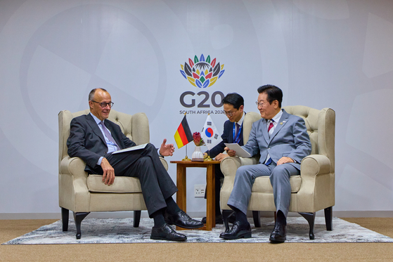 President Lee Jae Myung, right, and German Chancellor Friedrich Merz speak during their summit held on the sidelines of the Group of 20 summit in Johannesburg, South Africa, on Nov. 22. [JOINT PRESS CORPS]