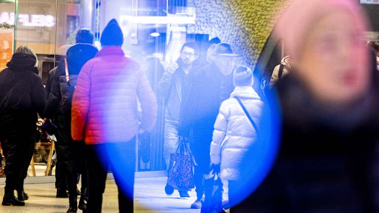 Photo shows people in a shopping centre.