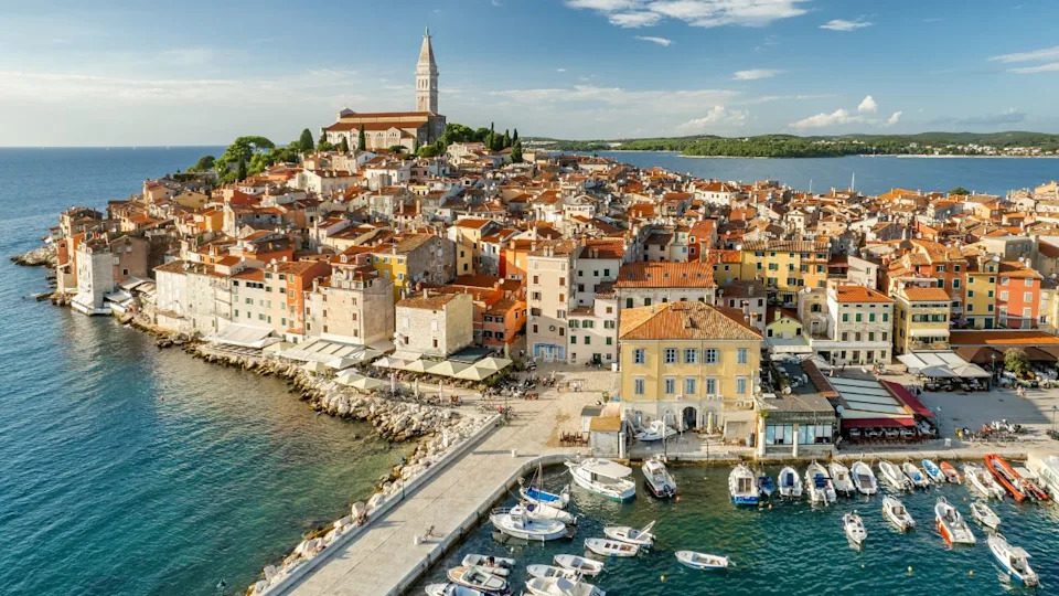 Aerial view of the Rovinj old town at sunset, famous ancient Croatian city at the Adriatic sea, Istria peninsula, Croatia. Rovinj cityscape, cathedral of St. Euphemia and historic buildings