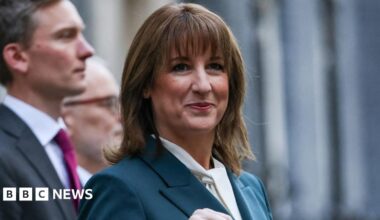 Chancellor Rachel Reeves standing in Downing Street with her Budget red box.