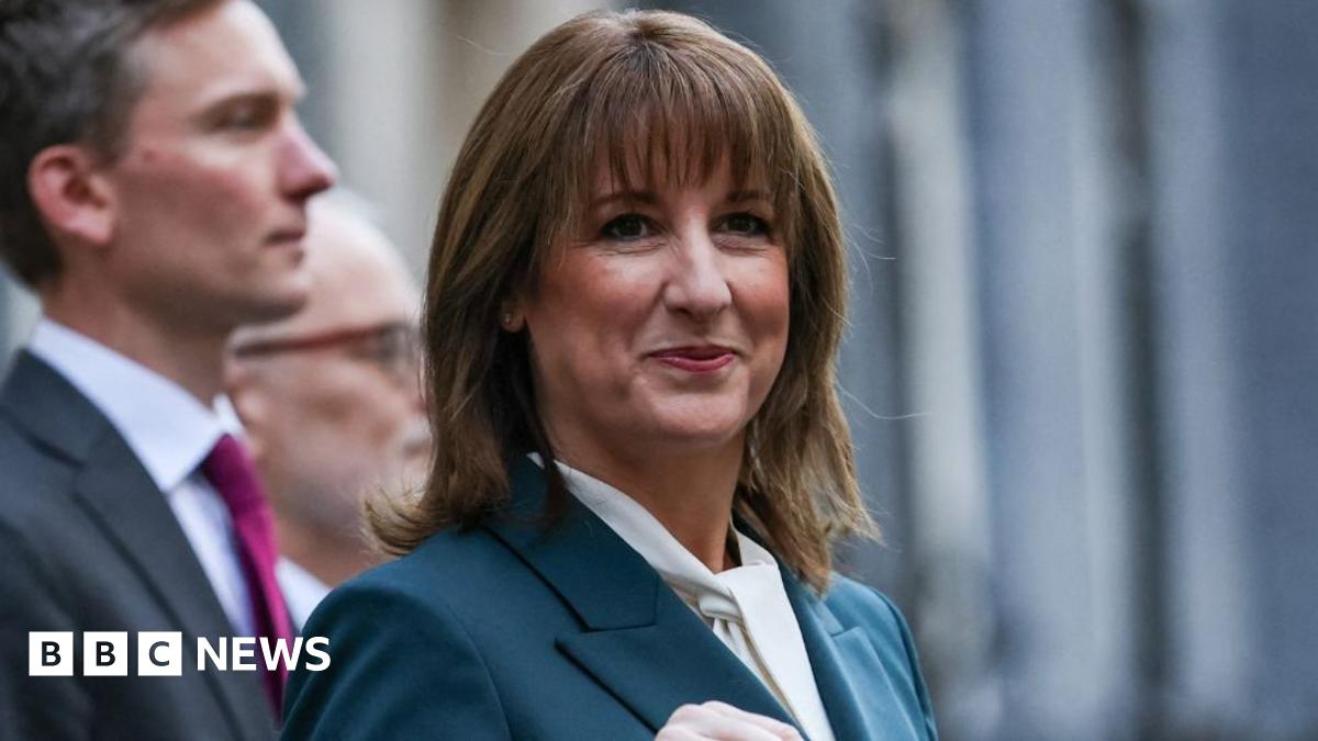 Chancellor Rachel Reeves standing in Downing Street with her Budget red box.