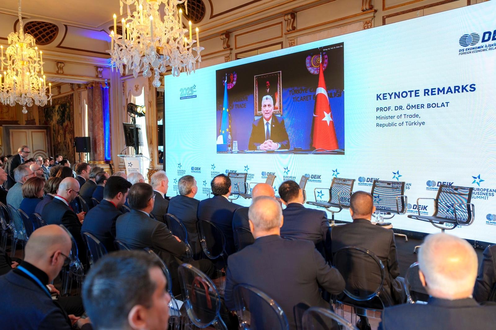 Trade Minister Ömer Bolat (on screen) speaks at the EU-Türkiye Business Summit, Brussels, Belgium, Nov. 17, 2025. (Courtesy of DEIK)