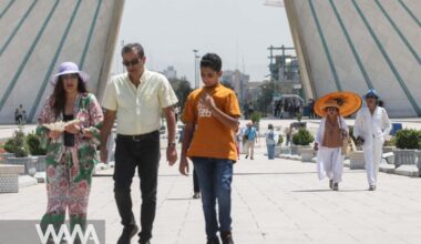 Tourists walk in a street during the heat surge in Tehran, Iran August 2, 2023. Majid Asgaripour/WANA (West Asia News Agency)