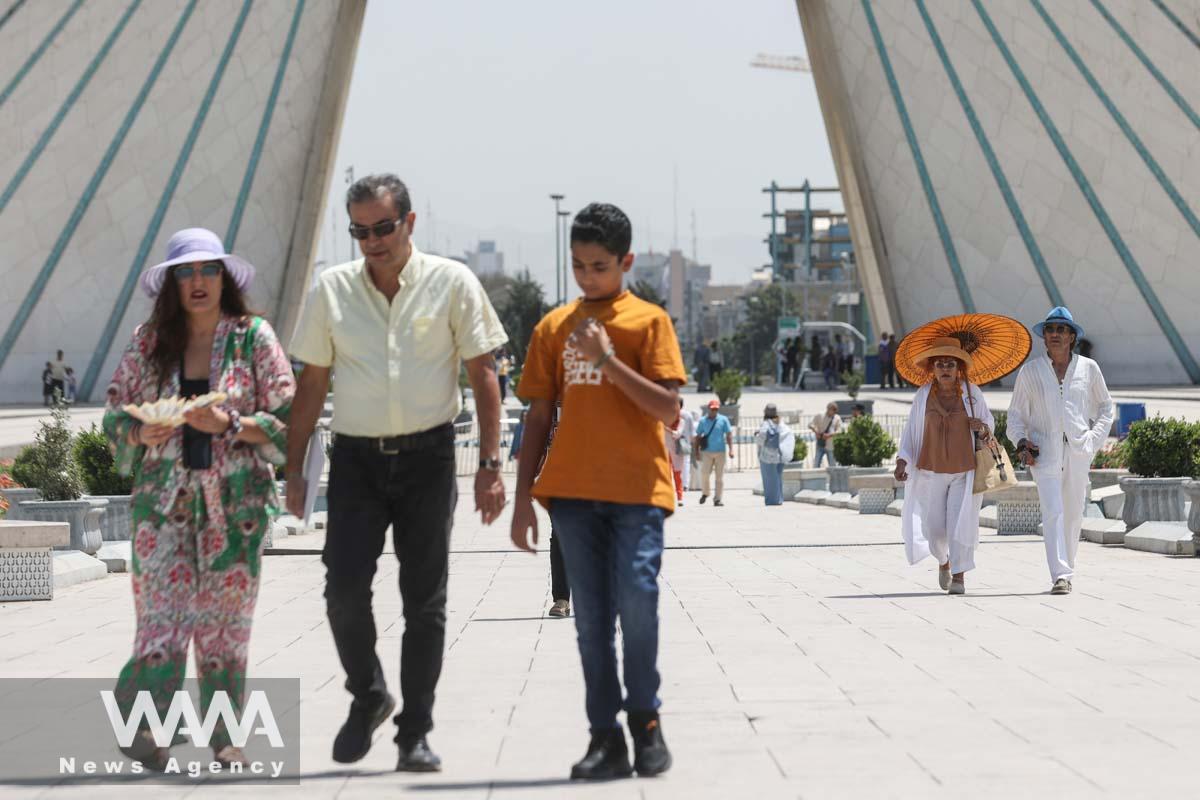 Tourists walk in a street during the heat surge in Tehran, Iran August 2, 2023. Majid Asgaripour/WANA (West Asia News Agency)