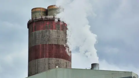 Waldo Swiegers/Bloomberg via Getty Images Vapour rises from a chimney at the Eskom Holdings SOC Ltd. Medupi coal-fired power station in Lephalale, South Africa, on Thursday, May 19, 2022. South Africas Eskom is increasing power cuts to prevent a total collapse of the grid as issues grow from lack of imports to breakdowns at its coal-fired plants