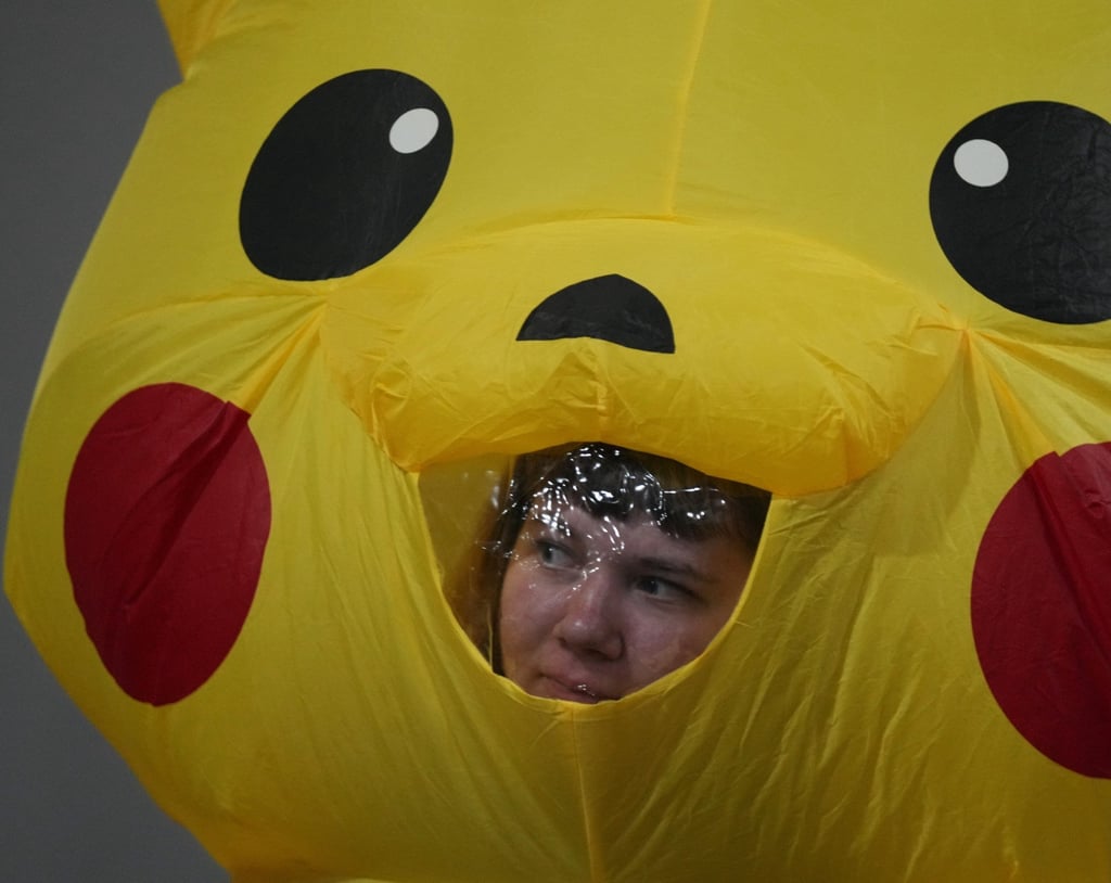 An activist peeks out of a Pikachu costume at the Cop30 summit on Friday. Photo: AP