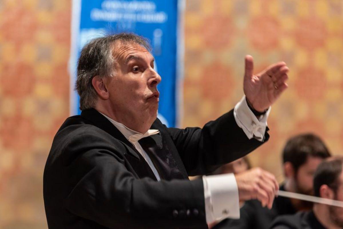 Composer Pietro Cangiano conducting the <em>Orchestra Filarmonica Umbra Vittorio Calamani</em>.
