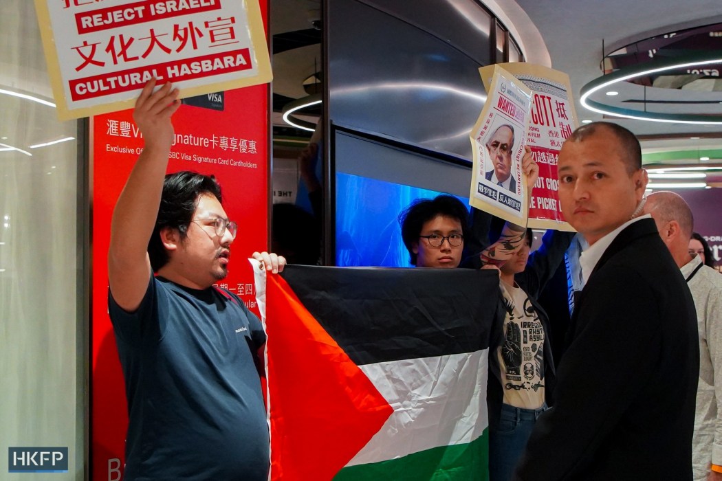 HK Anti-war Mobilization activists Yu Wai-pan (left) and YY (centre) protest the Israeli consulate-backed Hong Kong Jewish Film Festival at Emperor Cinemas in Causeway Bay on November 8, 2025. Photo: HKFP.