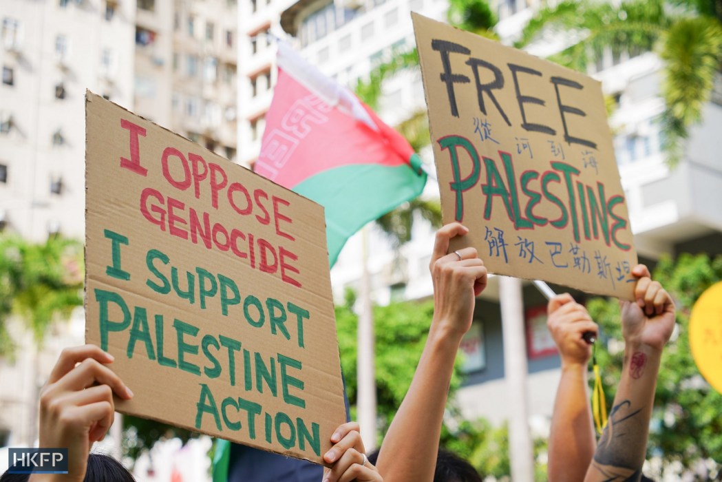 Anti-war protesters hold up placards opposing Israel's war in Gaza, on October 7, 2025.