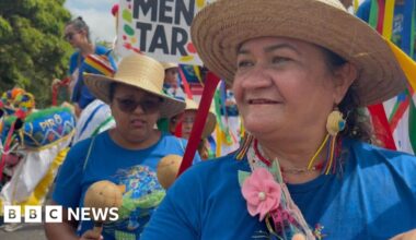 Loud and colourful crowds march outside UN climate summit