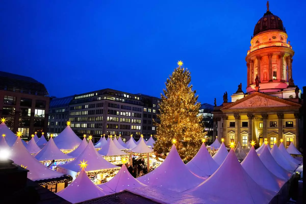 Lights illuminate the Christmas market at the Gendarmen Markt square in Berlin, Germany, Monday, Nov. 24, 2025. (AP Photo/Markus Schreiber)