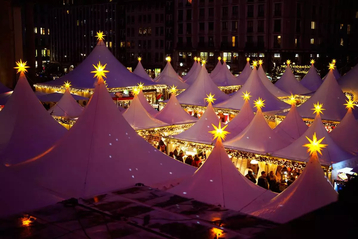 Lights illuminate the Christmas market at the Gendarmen Markt square in Berlin, Germany, Monday, Nov. 24, 2025. (AP Photo/Markus Schreiber)