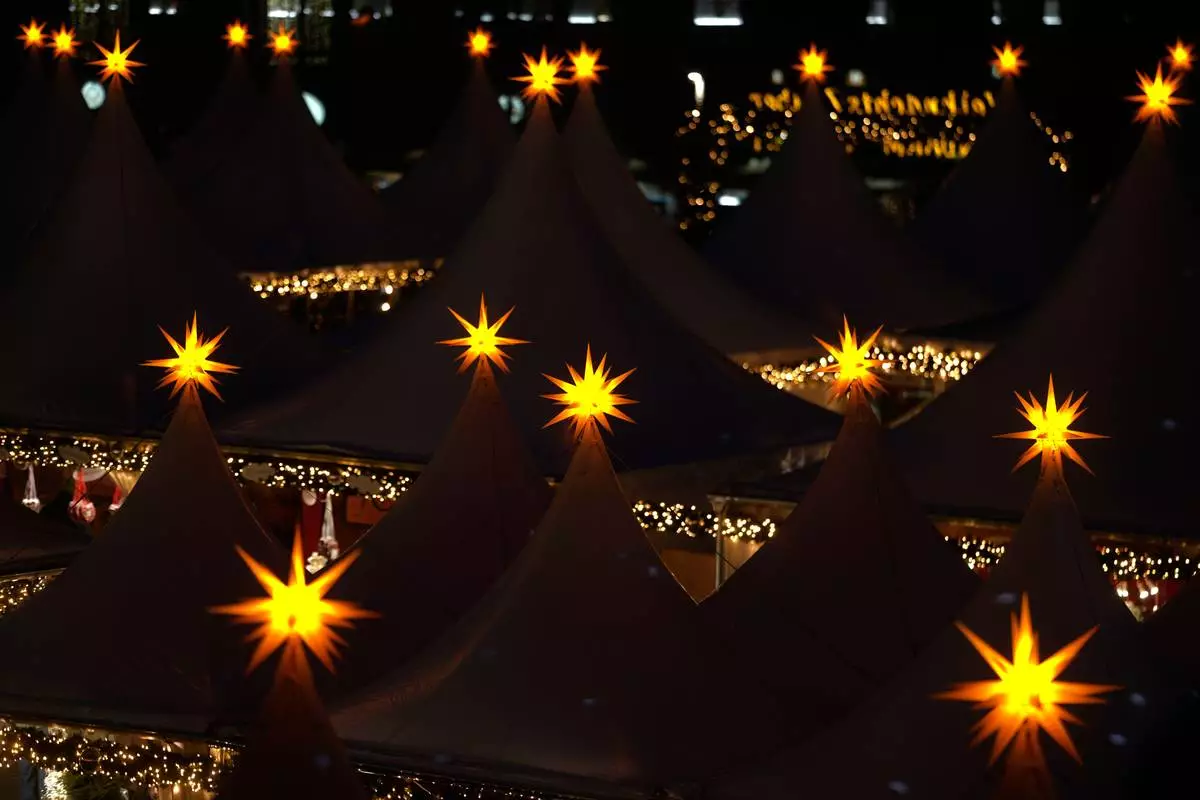 Lights illuminate the Christmas market at the Gendarmen Markt square in Berlin, Germany, Monday, Nov. 24, 2025. (AP Photo/Markus Schreiber)