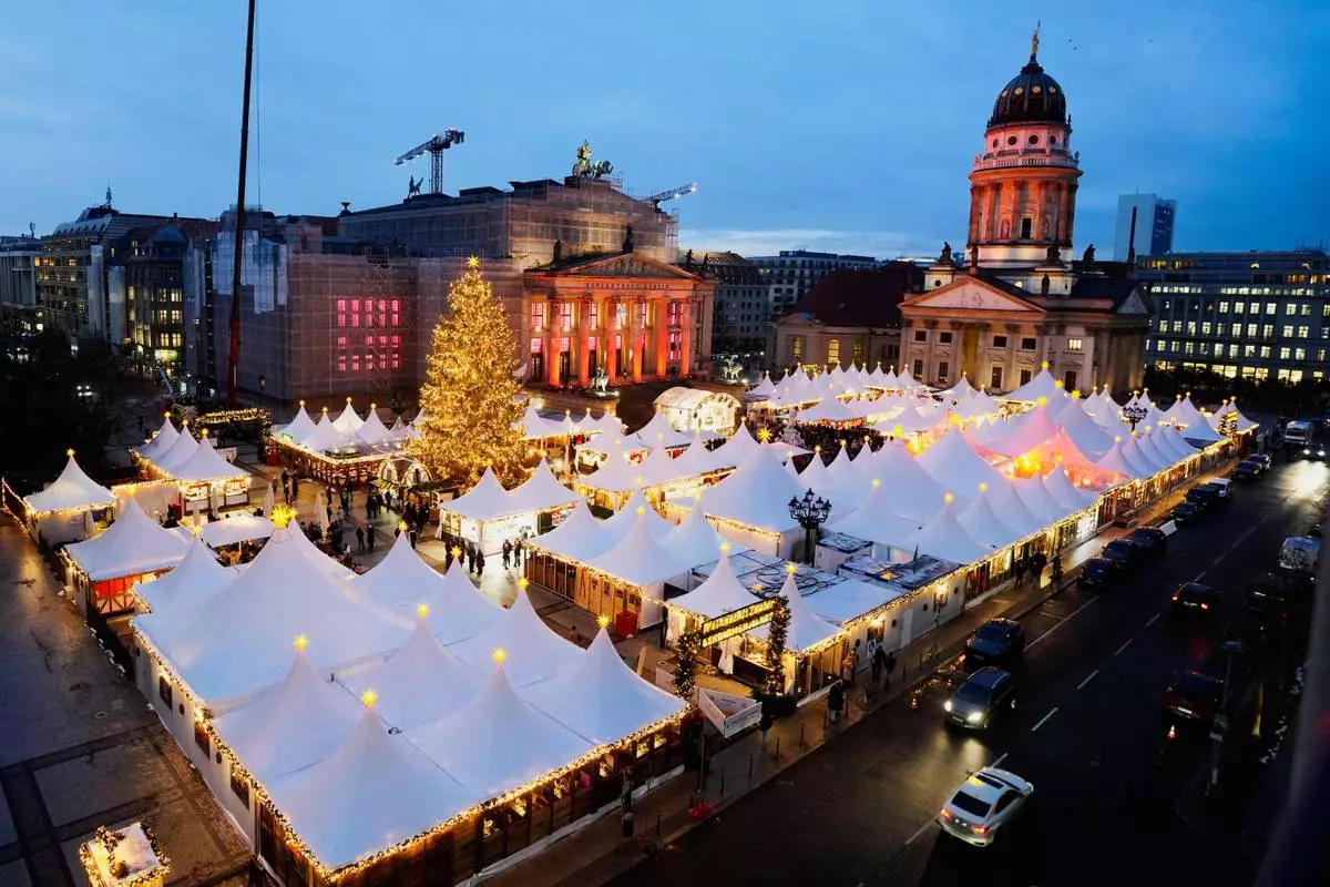 Lights illuminate the Christmas market at the Gendarmen Markt square in Berlin, Germany, Monday, Nov. 24, 2025. (AP Photo/Markus Schreiber)
