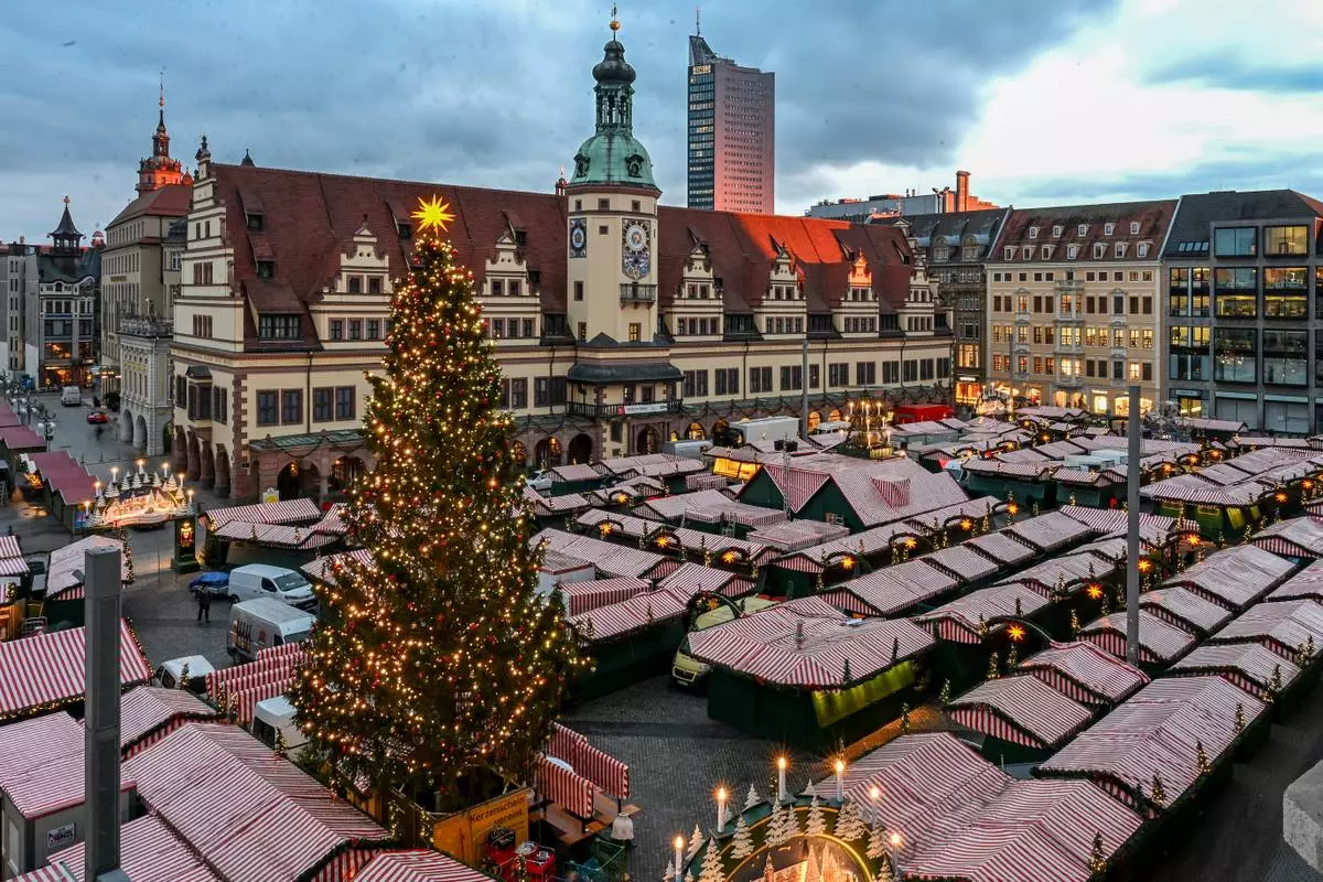 The Christmas tree at Leipzig's Christmas market is illuminated during a lighting rehearsal, in Leipzig, Germany, Thursday, Nov. 20, 2025. (Jennifer Brückner/dpa via AP)