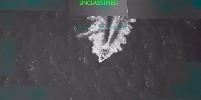 Black and white image of boat riding on the ocean.