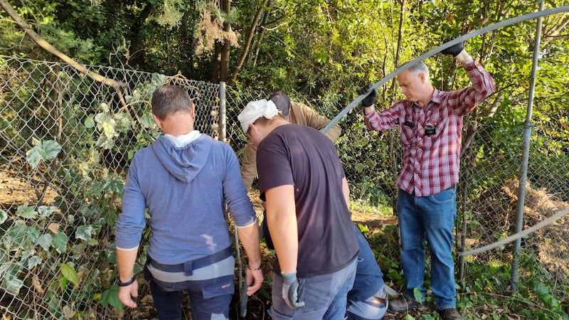 Adriatic North Mission President Brian Cordray, right, works with Debeli Rtič Health Resort workers to help clean up an area of the resort on the Adriatic Sea in Slovenia on Friday, Nov. 7, 2025.
