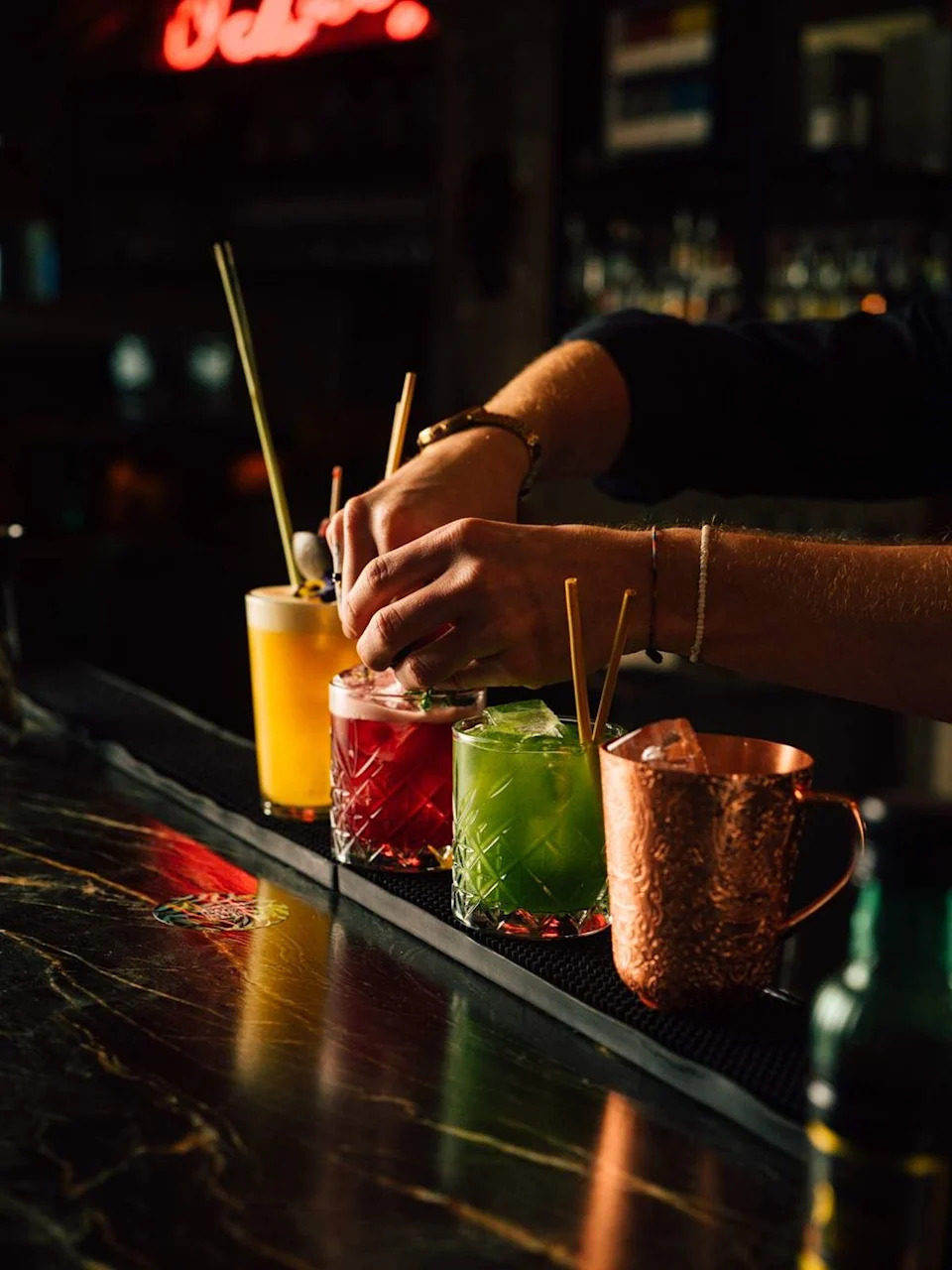 Four cocktails lined up at a bar in Vienna