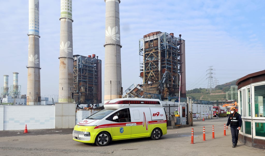 An ambulance carrying a victim leaves from the scene of where a tower collapsed in South Korea on Friday. Photo: AP An ambulance carrying a victim leaves from the scene of where a tower collapsed in South Korea on Friday. Photo: AP