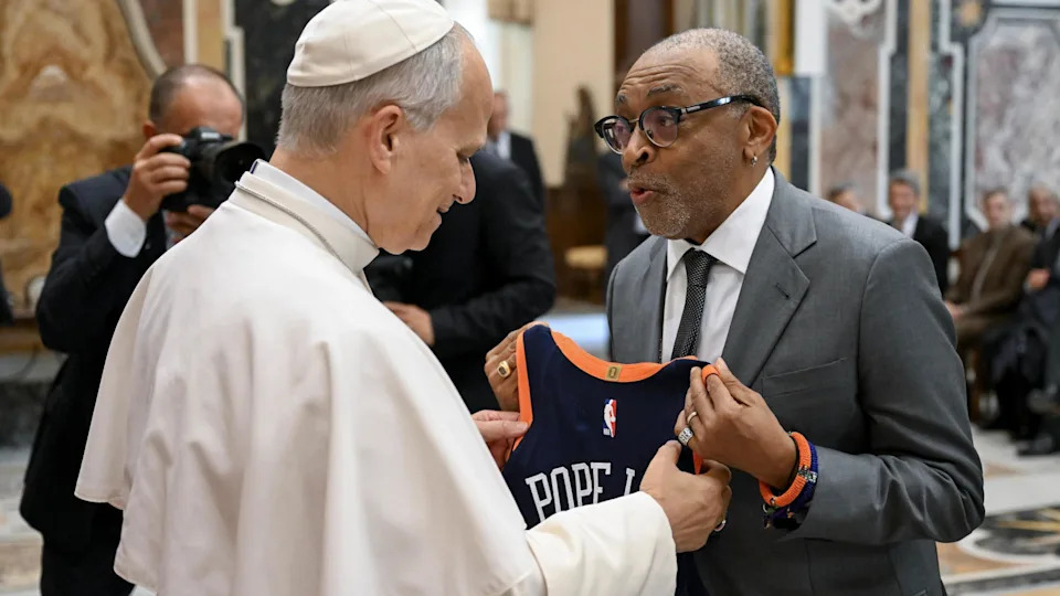 Pope Leo XIV greets US filmmaker Spike Lee during a special audience with the World of Cinema, at the Apostolic Palace, Vatican City. Lee hands him a New York Knicks shirt printed with 14 and "Pope Leo".
